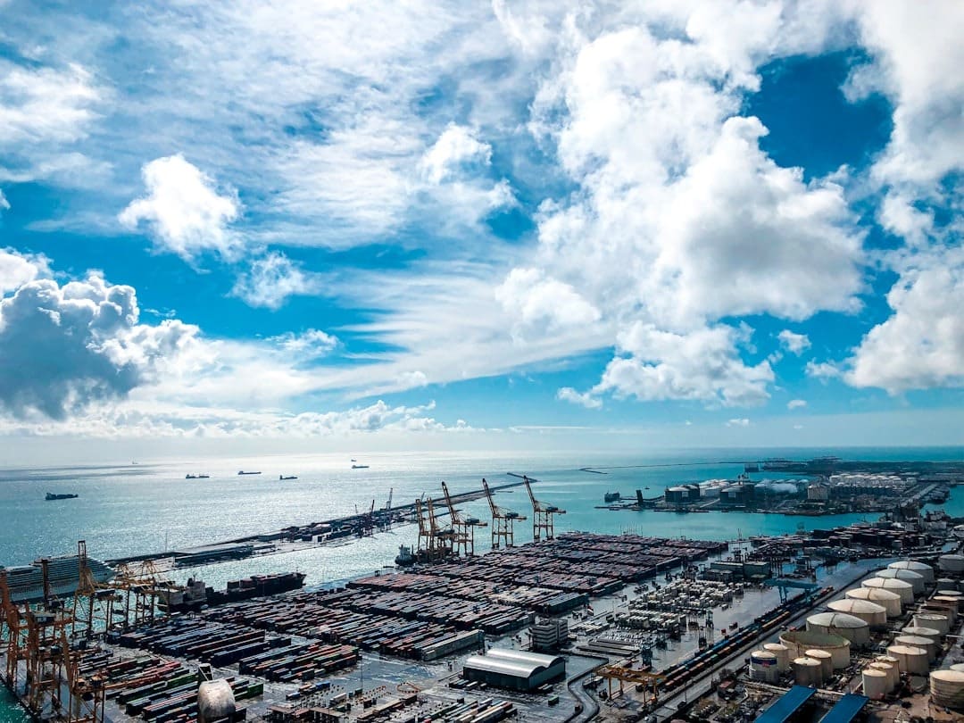 Aerial view of a busy commercial port with shipping containers and ships.